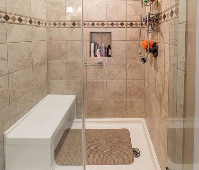 bathroom with a tile shower