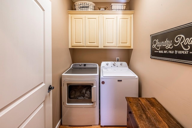 laundry room featuring cabinets and washing machine and clothes dryer