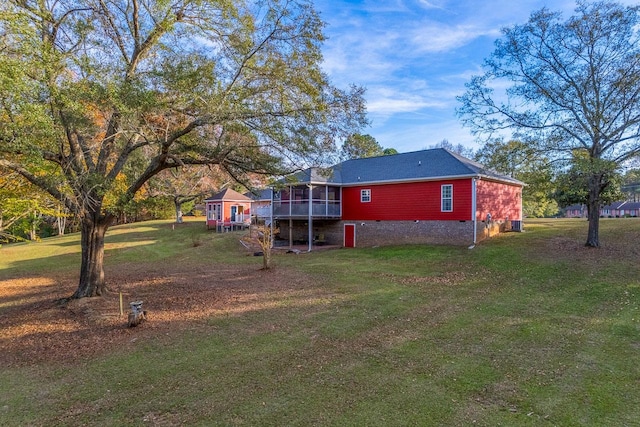 view of yard featuring a sunroom and a deck