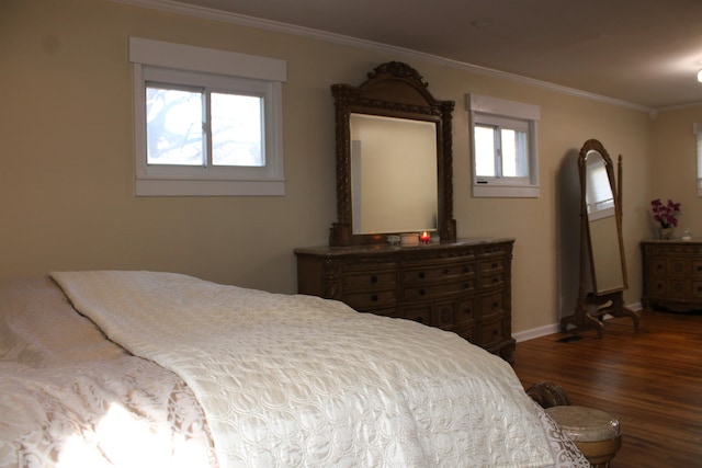 bedroom featuring dark hardwood / wood-style floors, multiple windows, and crown molding