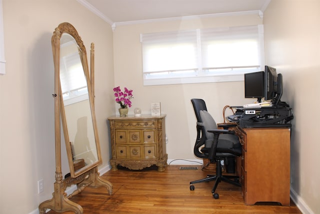 office area with wood-type flooring and ornamental molding