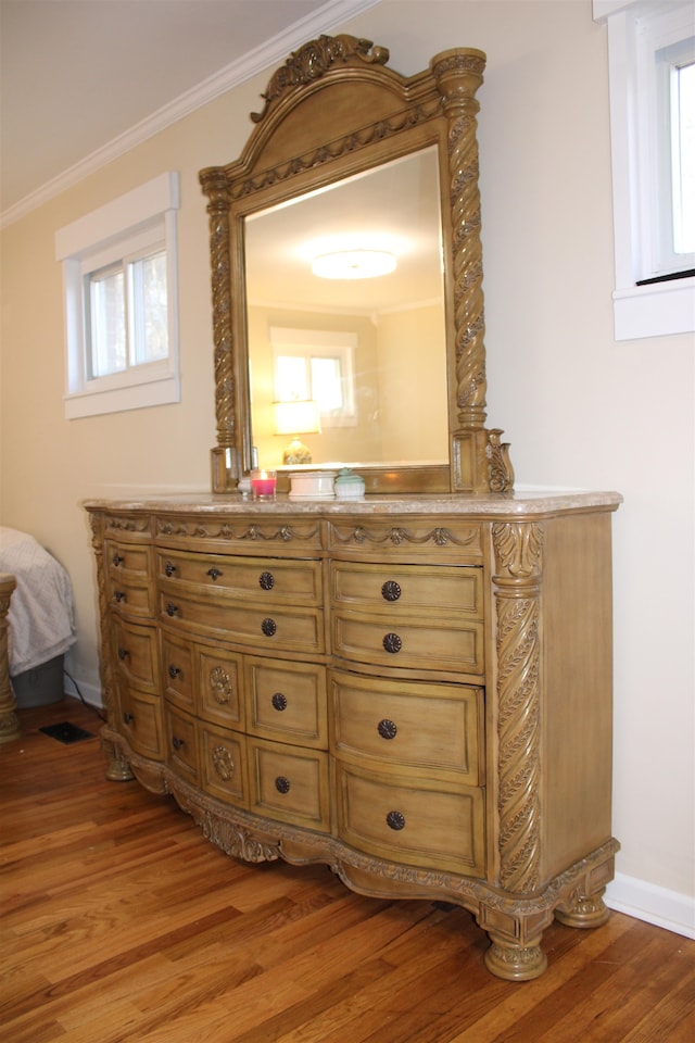 bathroom with crown molding, vanity, and wood-type flooring