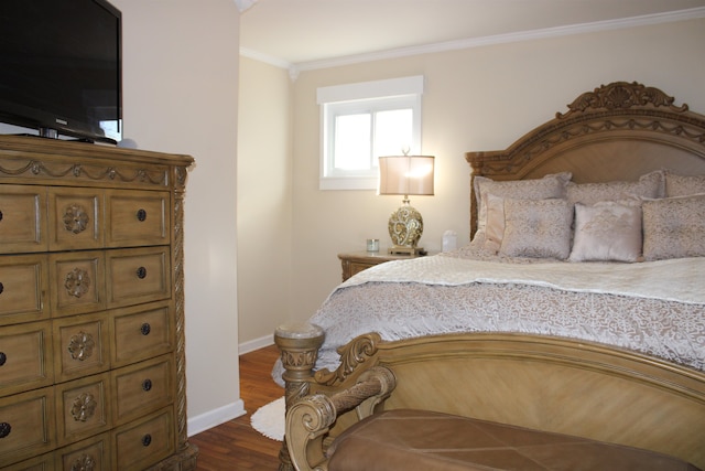 bedroom with dark hardwood / wood-style flooring and crown molding