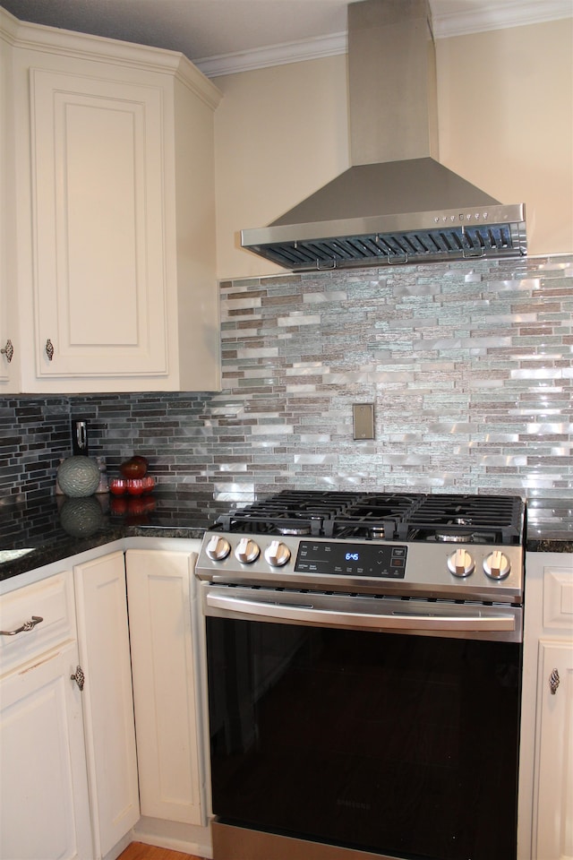 kitchen with backsplash, wall chimney exhaust hood, stainless steel stove, and ornamental molding