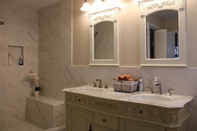 bathroom with backsplash, vanity, and tile walls