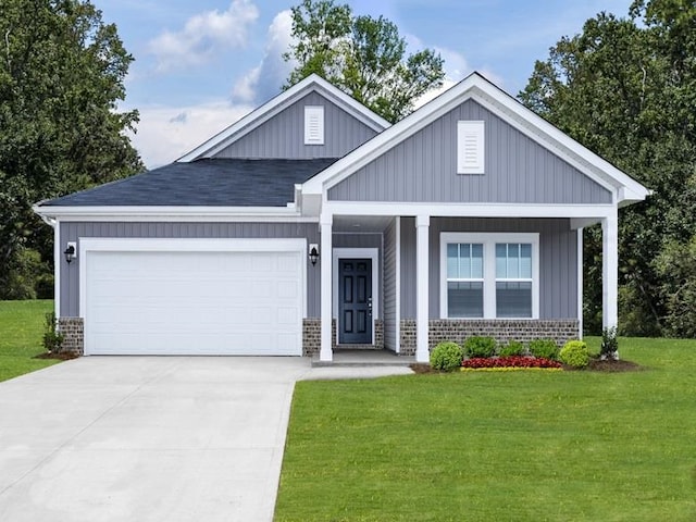 craftsman-style house with covered porch, a garage, and a front yard