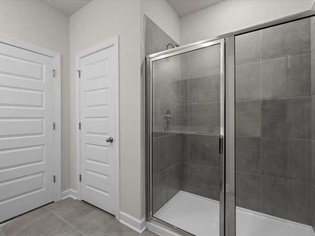 bathroom with tile patterned floors and walk in shower