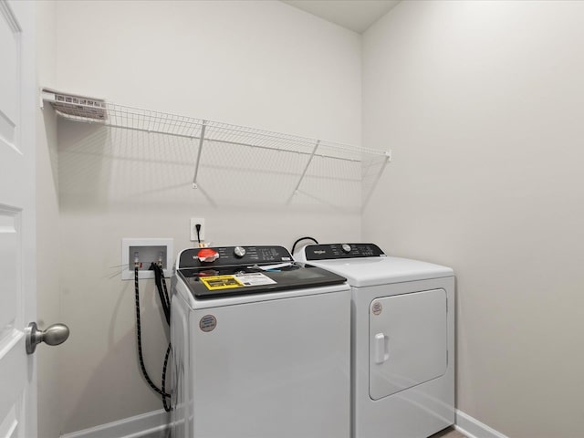 laundry room featuring washing machine and clothes dryer