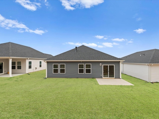 rear view of property featuring a patio and a lawn