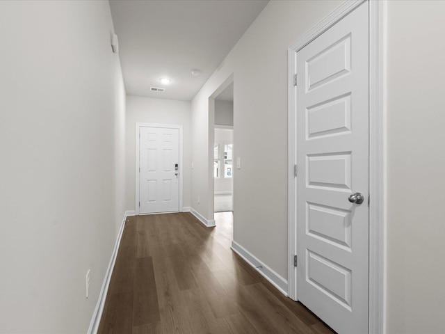 hall with dark wood-type flooring