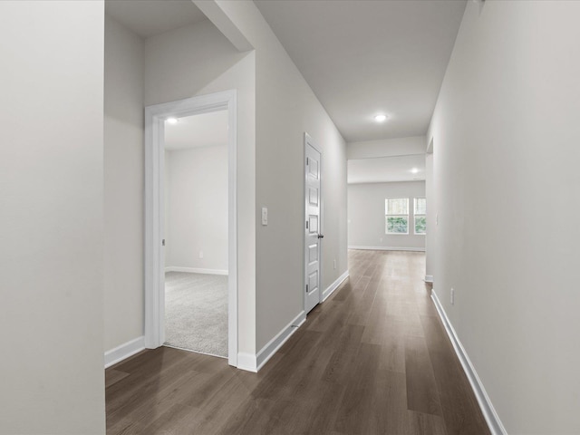 corridor with dark hardwood / wood-style flooring