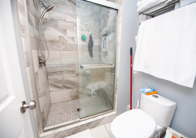 bathroom featuring an enclosed shower and toilet