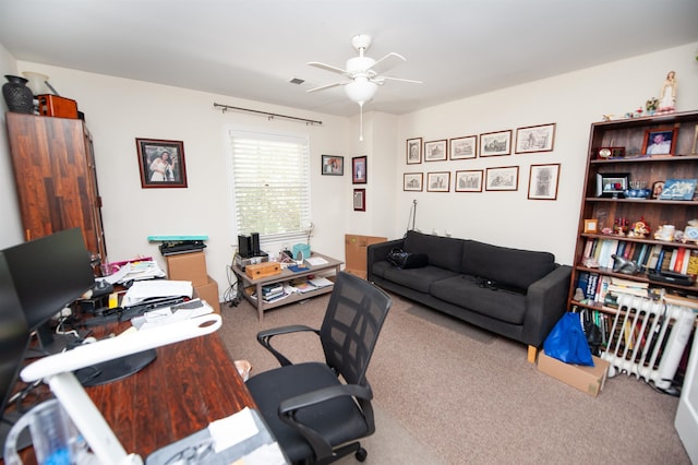 carpeted home office with ceiling fan