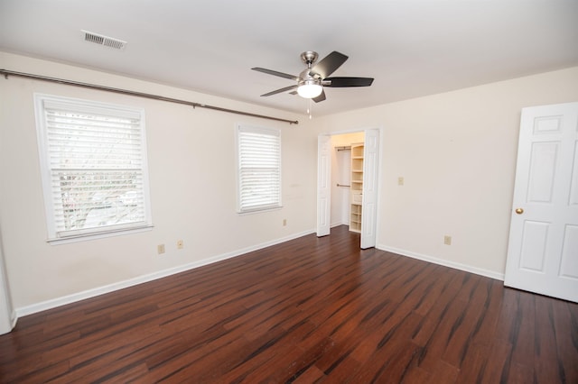 spare room with dark hardwood / wood-style flooring, plenty of natural light, and ceiling fan