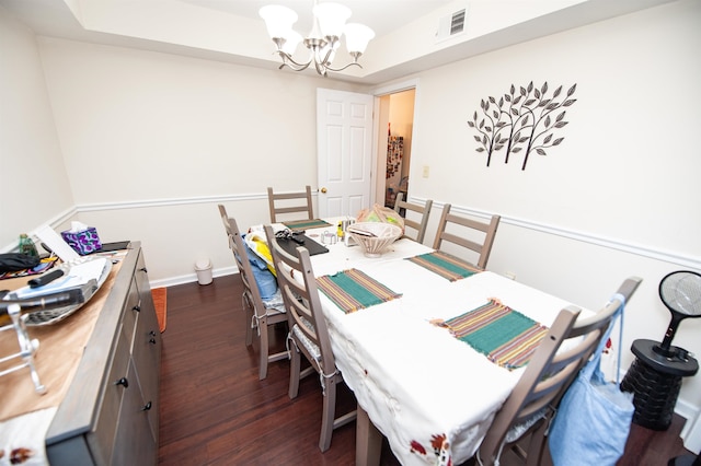 dining area featuring an inviting chandelier and dark hardwood / wood-style flooring