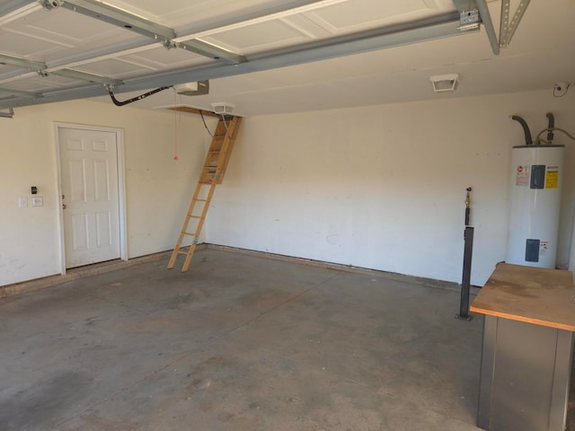 garage featuring a garage door opener and water heater