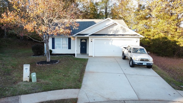 view of front of house with a front yard and a garage