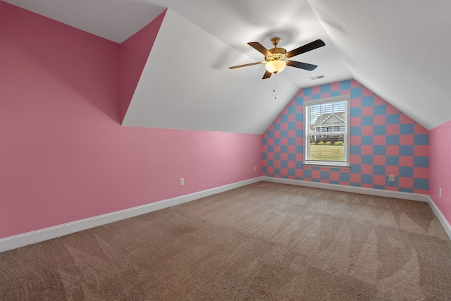 additional living space with ceiling fan, carpet, and vaulted ceiling