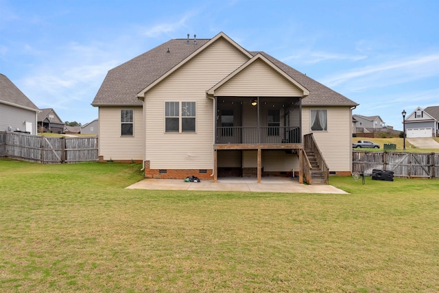 rear view of property featuring a lawn, a patio area, and a sunroom