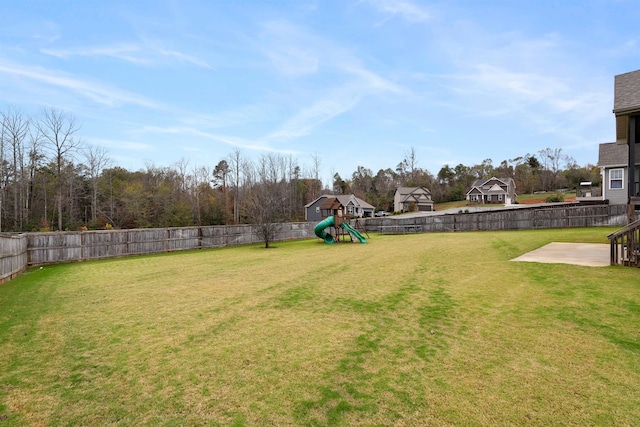 view of yard featuring a playground and a patio area