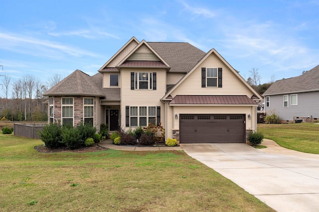 craftsman house featuring a garage and a front lawn