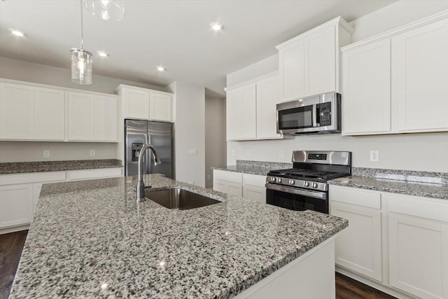 kitchen with dark hardwood / wood-style flooring, an island with sink, stainless steel appliances, and sink