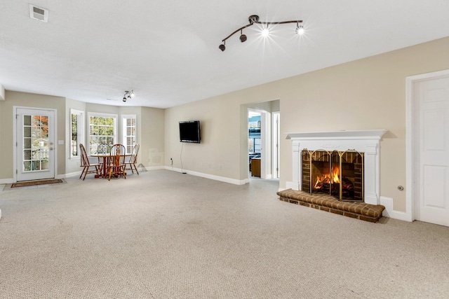 unfurnished living room featuring carpet flooring and a fireplace