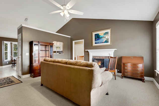 carpeted living room featuring ceiling fan, high vaulted ceiling, and a brick fireplace