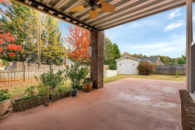 view of patio / terrace with ceiling fan and a shed