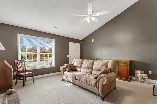 carpeted living room with ceiling fan, a textured ceiling, and high vaulted ceiling