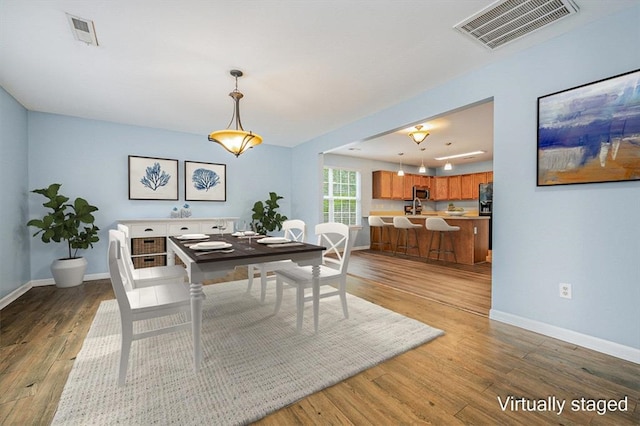 dining space with hardwood / wood-style flooring