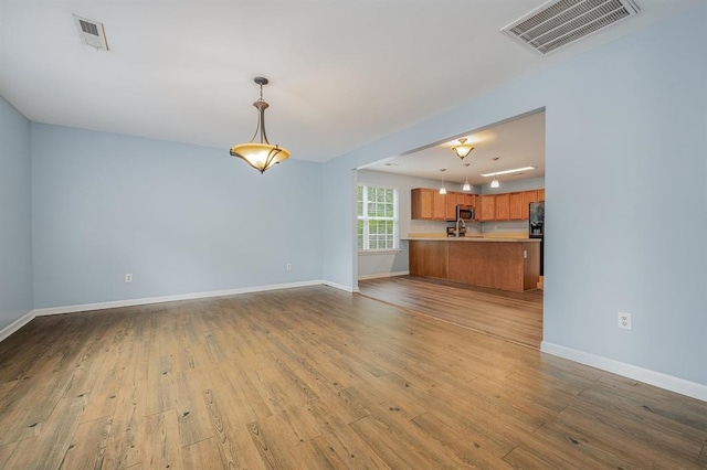 unfurnished living room featuring light hardwood / wood-style flooring