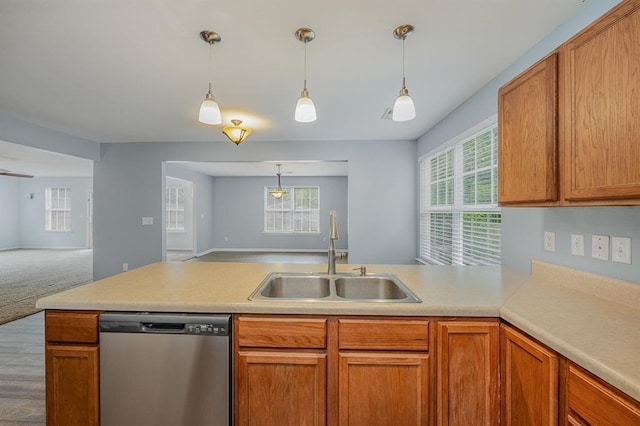 kitchen featuring carpet flooring, dishwasher, plenty of natural light, and sink