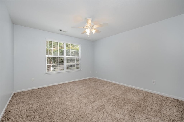 carpeted spare room with ceiling fan