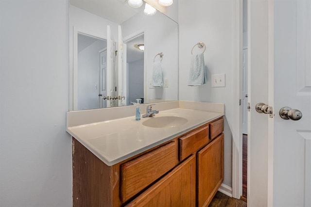 bathroom with hardwood / wood-style floors and vanity