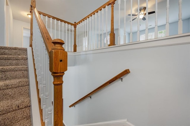 staircase featuring ceiling fan