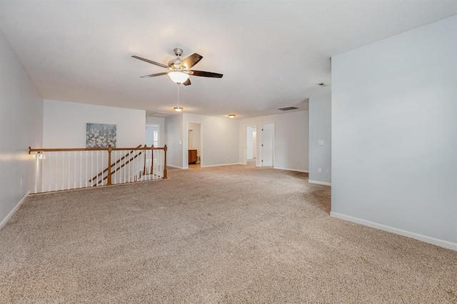 carpeted spare room with ceiling fan