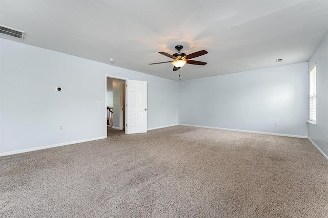 carpeted spare room with ceiling fan