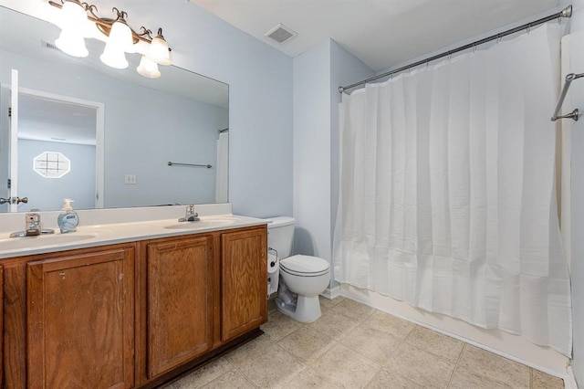 full bathroom with vanity, toilet, and shower / tub combo