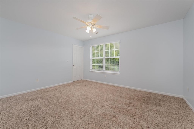 empty room with ceiling fan and carpet floors