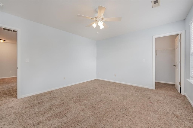 spare room featuring carpet and ceiling fan