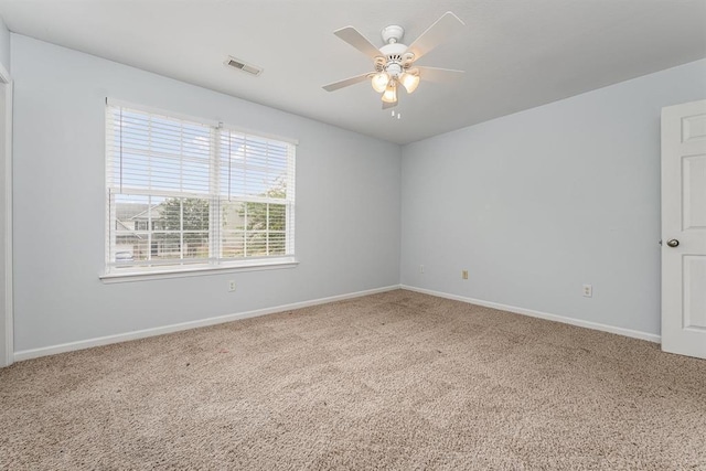 unfurnished room with carpet flooring, ceiling fan, and plenty of natural light