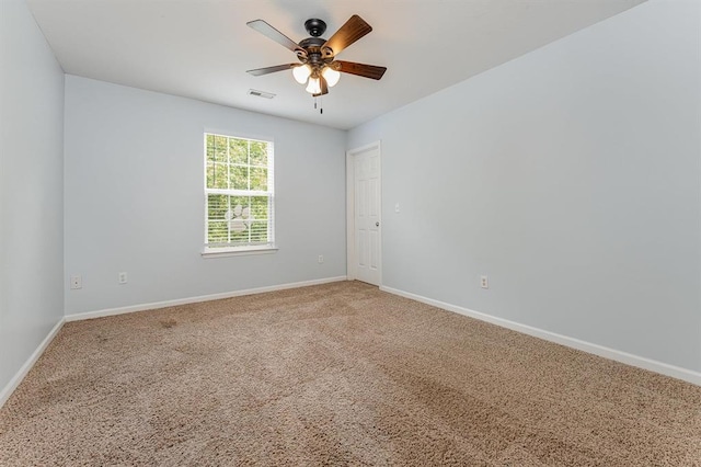 carpeted spare room with ceiling fan