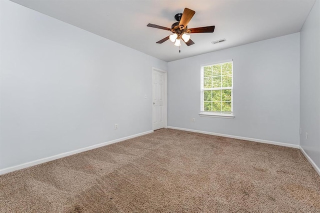 unfurnished room featuring ceiling fan and carpet