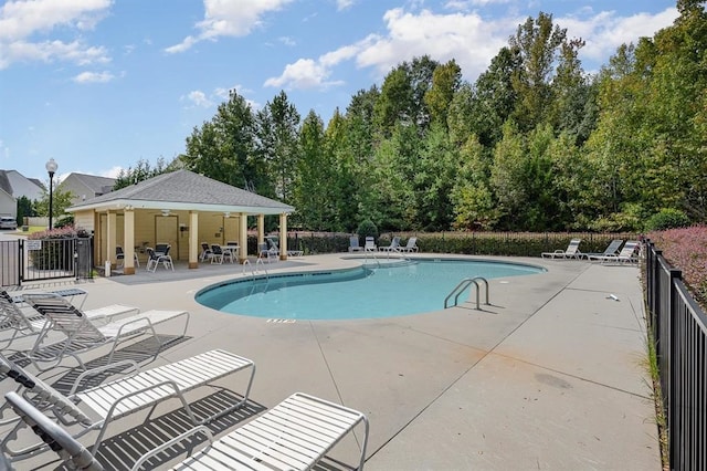 view of pool with ceiling fan and a patio area