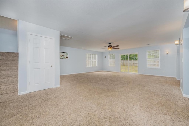 spare room with ceiling fan and light colored carpet