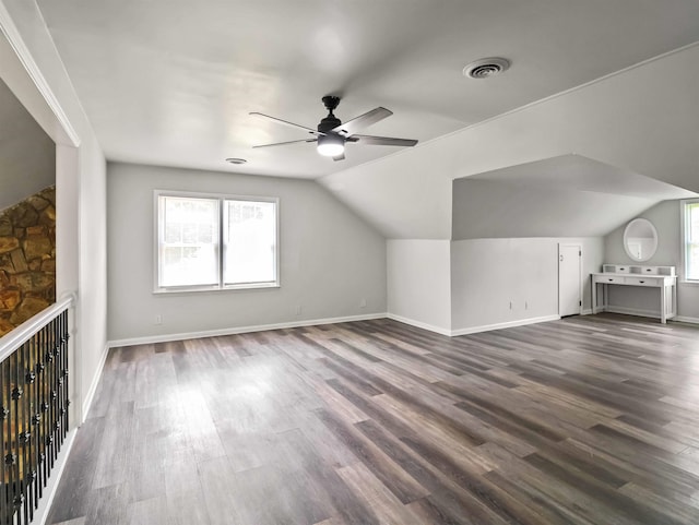 bonus room featuring dark hardwood / wood-style floors, vaulted ceiling, and ceiling fan