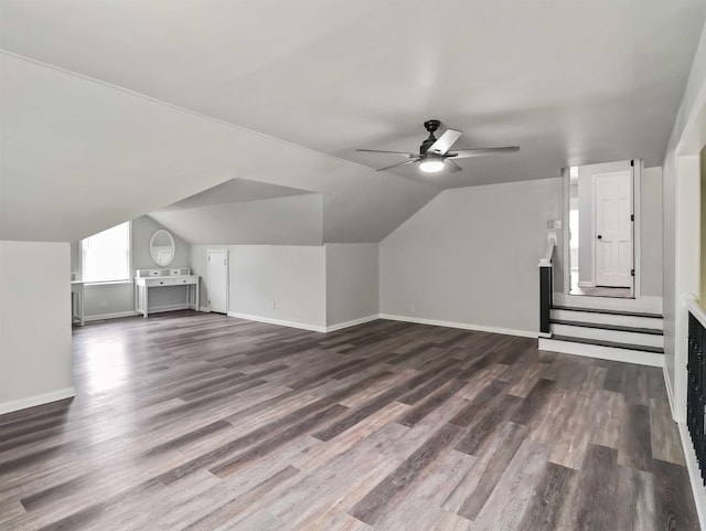 bonus room with vaulted ceiling, ceiling fan, and dark wood-type flooring