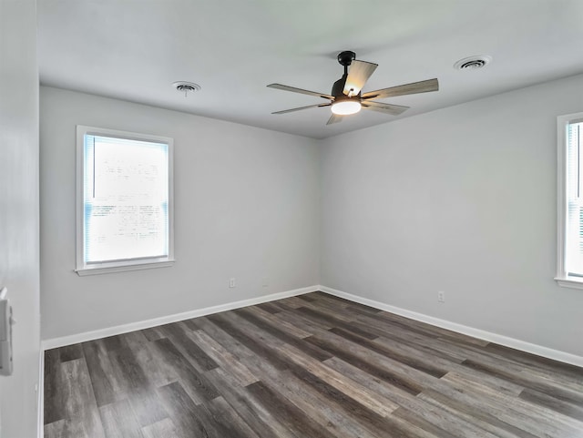 spare room with dark hardwood / wood-style flooring, plenty of natural light, and ceiling fan