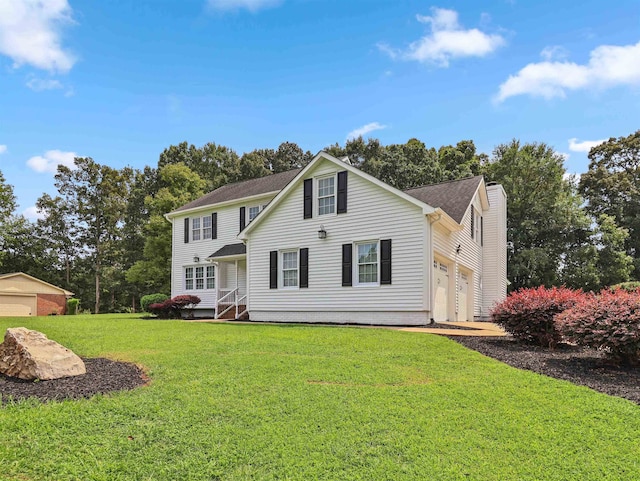 view of front of property with a front yard and a garage